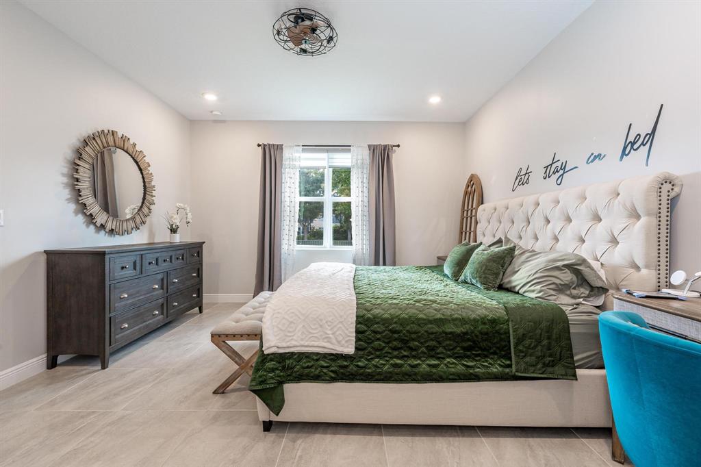 4185 Marina Way Deerfield Beach, FL 33064 - Photo 24 of 40 a bedroom with a bed and window