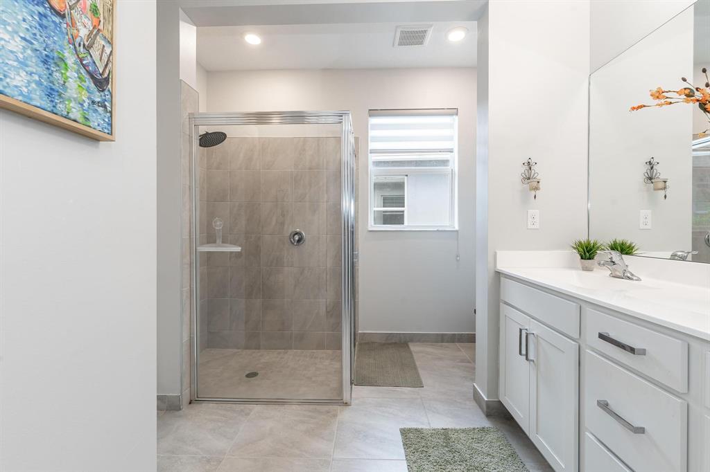 4185 Marina Way Deerfield Beach, FL 33064 - Photo 28 of 40 a bathroom with a shower sink and mirror