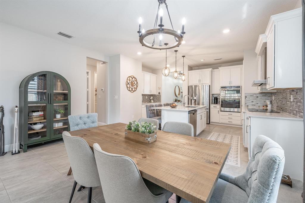 4185 Marina Way Deerfield Beach, FL 33064 - Photo 30 of 40 a view of a dining room with furniture and wooden floor