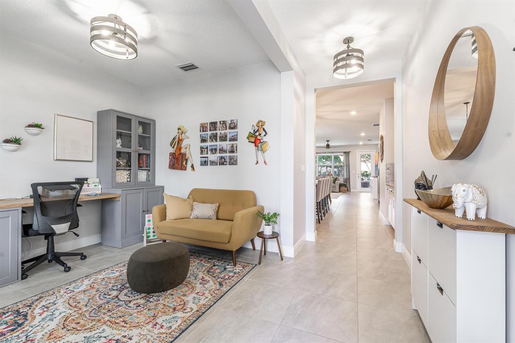 4185 Marina Way Deerfield Beach, FL 33064 - Photo 10 of 40 a living room with furniture a rug and a mirror