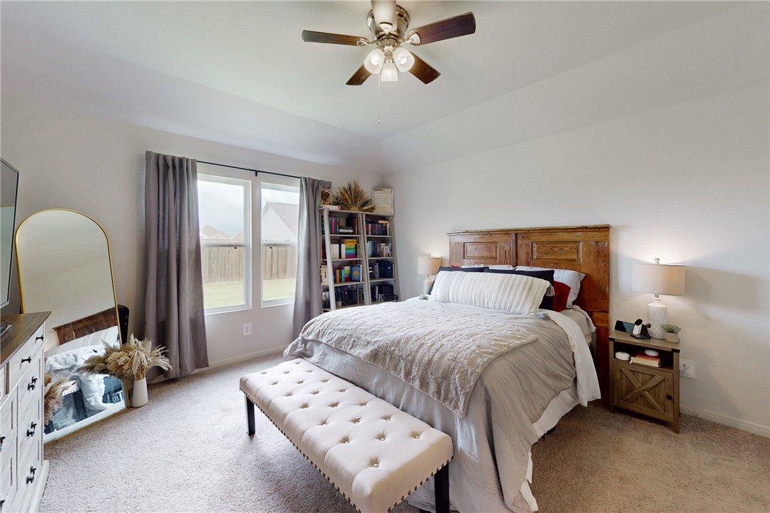 137 Windmill Road Somerville, TX 77879 - Photo 11 of 22 a bedroom with a bed and a chandelier