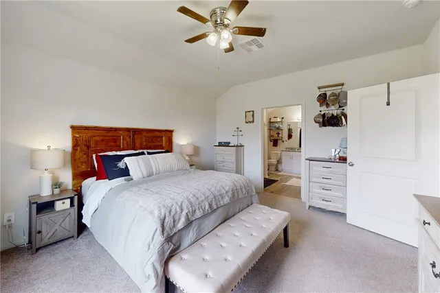 a bedroom with a bed and ceiling fan