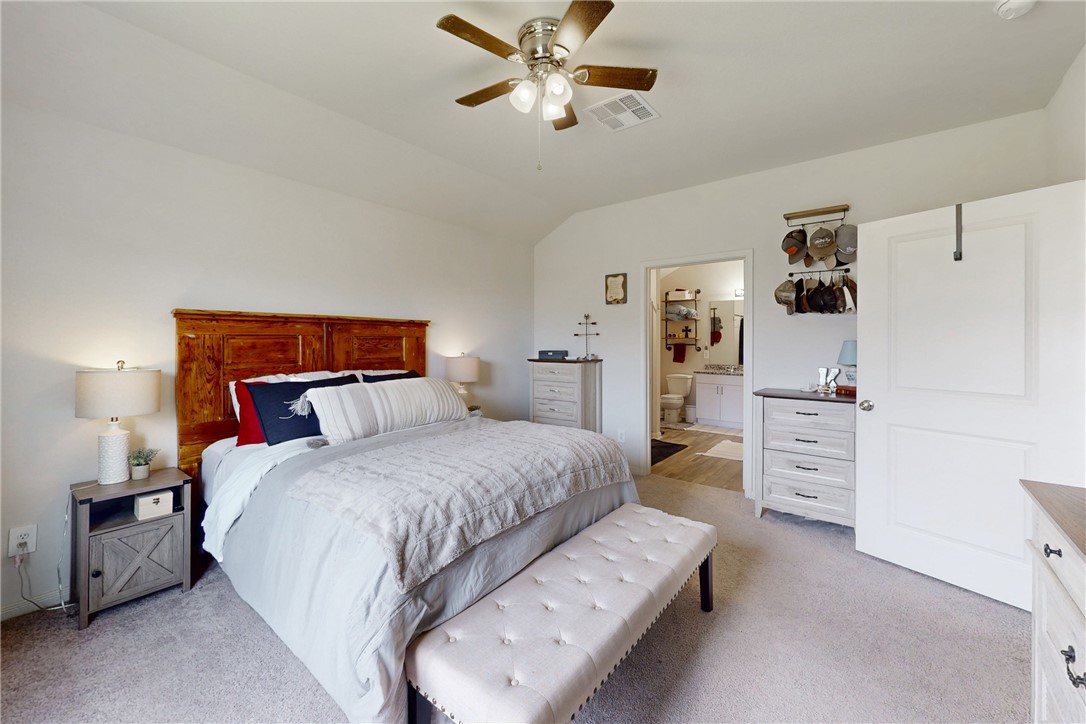 137 Windmill Road Somerville, TX 77879 - Photo 12 of 22 a bedroom with a bed and ceiling fan