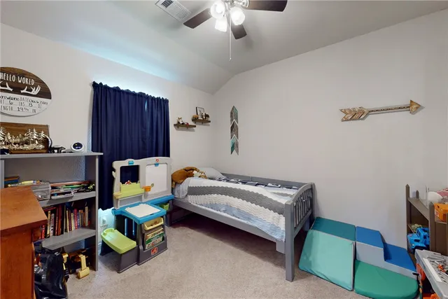 a bedroom with bed and a chandelier