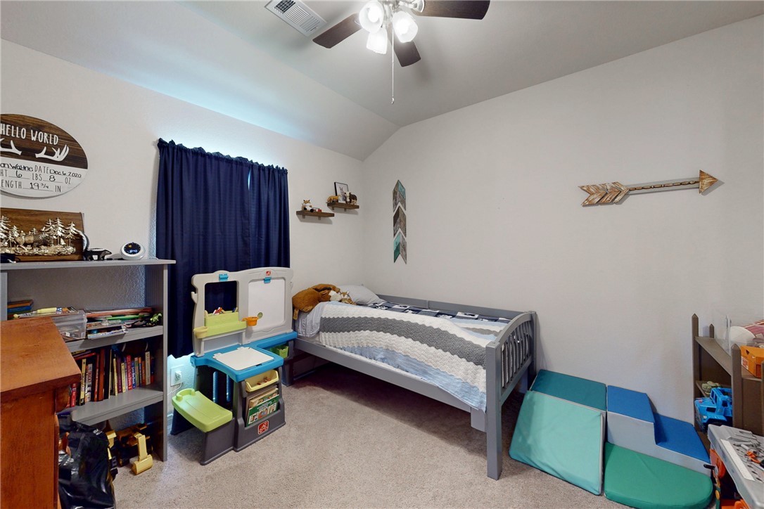 137 Windmill Road Somerville, TX 77879 - Photo 15 of 22 a bedroom with bed and a chandelier