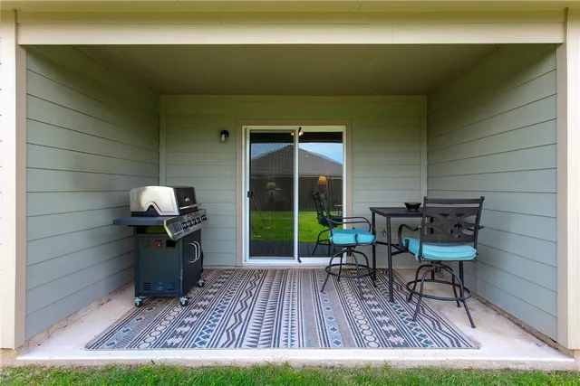 a view of two chairs in the patio