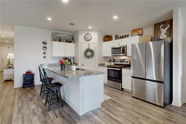 a kitchen with a refrigerator and a dining table