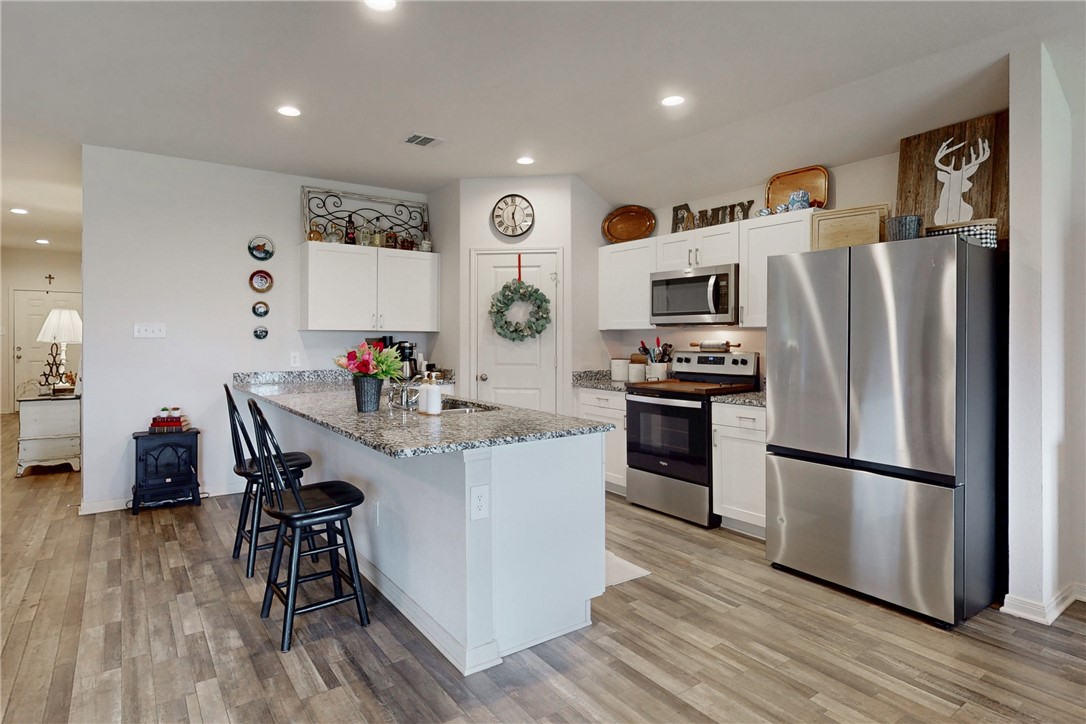 137 Windmill Road Somerville, TX 77879 - Photo 6 of 22 a kitchen with a refrigerator and a dining table