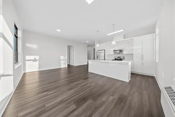 a view of a kitchen with wooden floor and a sink