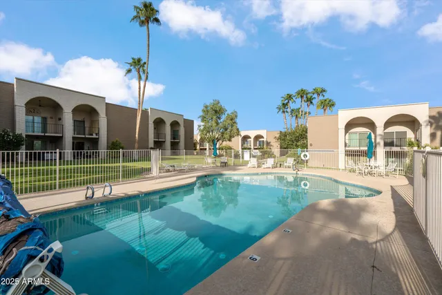 a view of a swimming pool with a lawn chairs