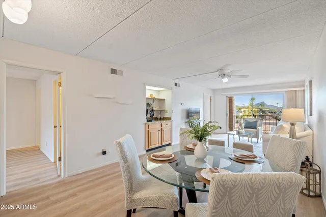 a living room with furniture a rug and white walls