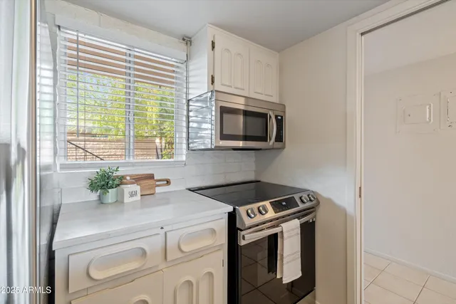 a kitchen with a table and chairs in it