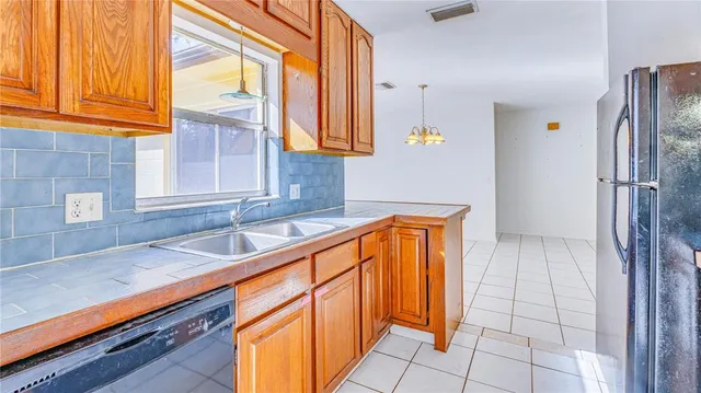 a kitchen view with granite countertop a stove a sink and a window