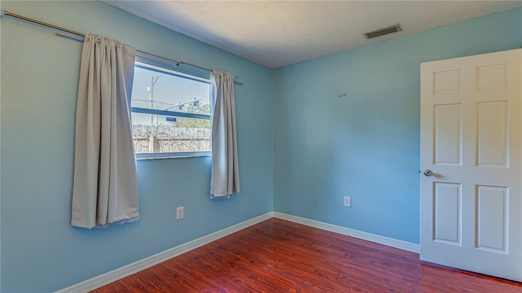 633 Huntington Street Brandon, FL 33511 - Photo 24 of 35 an empty room with wooden floor and windows