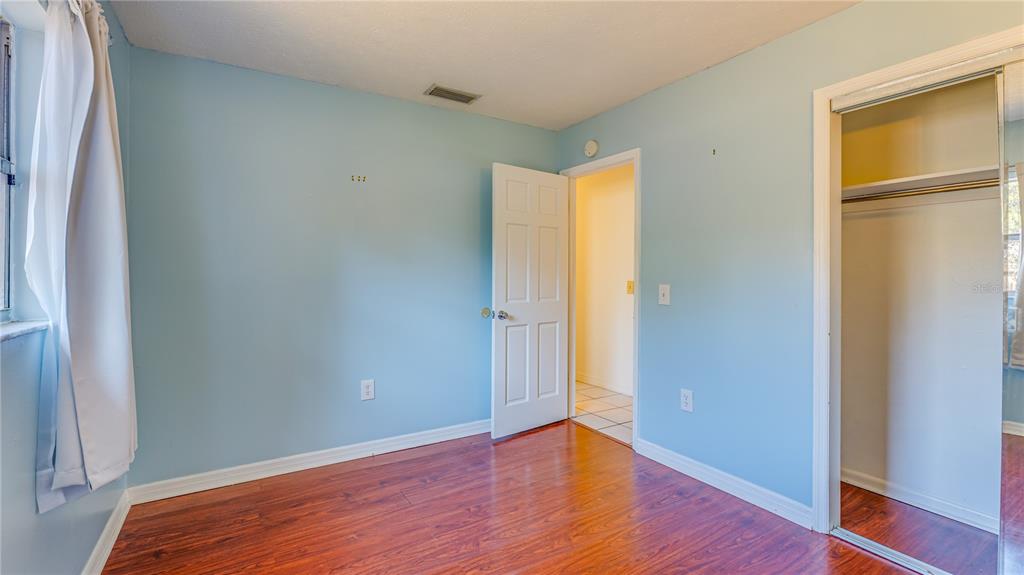 633 Huntington Street Brandon, FL 33511 - Photo 25 of 35 a view of an empty room with wooden floor and a window