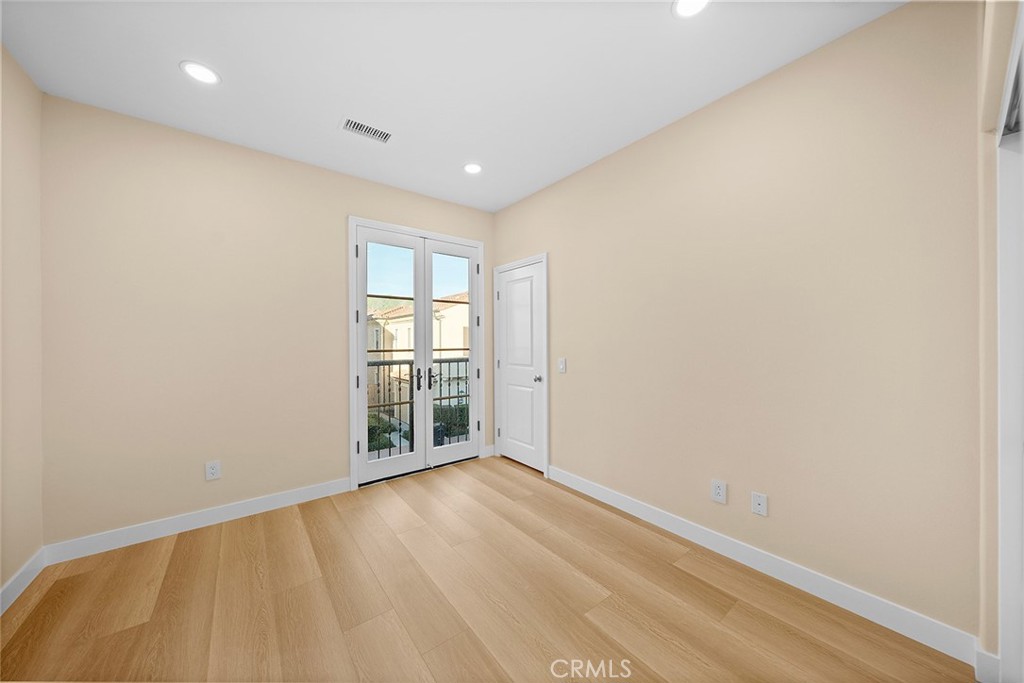 143 Rodeo Irvine, CA 92602 - Photo 27 of 37 a view of an empty room with wooden floor and a window