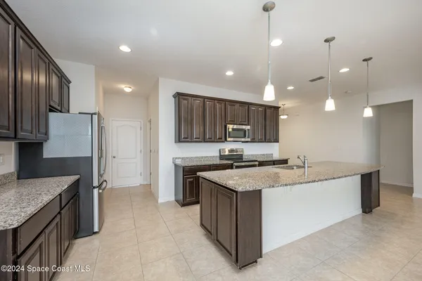 a kitchen with a sink stove and refrigerator
