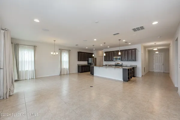 a view of kitchen with kitchen island and stainless steel appliances