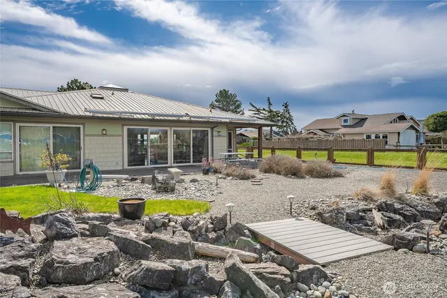 a view of a house with swimming pool and chairs