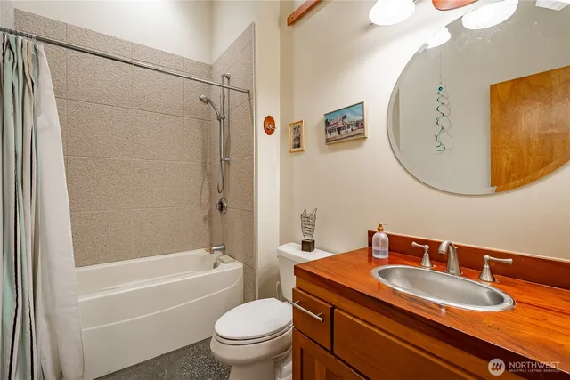 a bathroom with a sink a toilet and a mirror