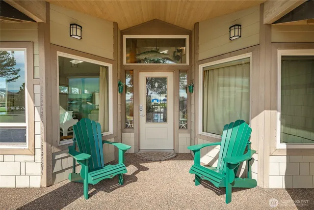 a front view of a house with outdoor seating and a garden