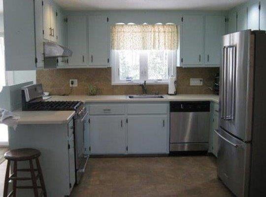 64 Ansel Howland Road Centerville, MA 02632 - Photo 12 of 31 a kitchen with a sink stove and refrigerator