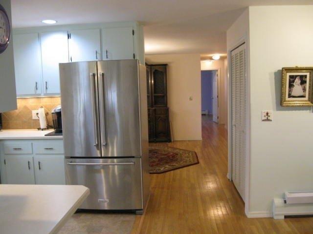 64 Ansel Howland Road Centerville, MA 02632 - Photo 15 of 31 a kitchen with stainless steel appliances a refrigerator and wooden floor