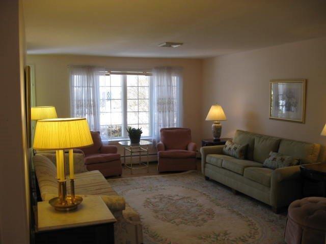 64 Ansel Howland Road Centerville, MA 02632 - Photo 20 of 31 a living room with furniture and a lamp