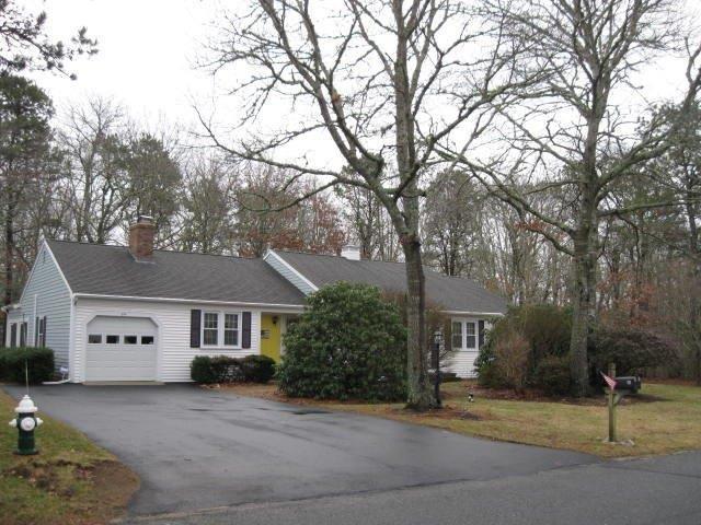 64 Ansel Howland Road Centerville, MA 02632 - Photo 2 of 31 a front view of a house with a tree