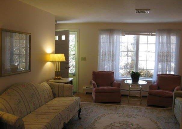 64 Ansel Howland Road Centerville, MA 02632 - Photo 21 of 31 a living room with furniture and a lamp