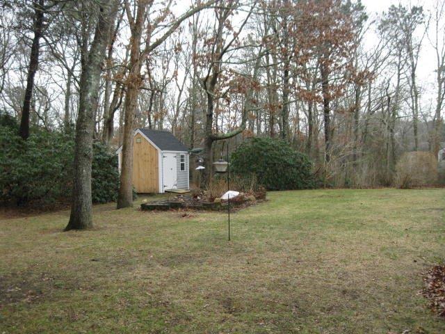 64 Ansel Howland Road Centerville, MA 02632 - Photo 28 of 31 a view of a house with backyard and trees