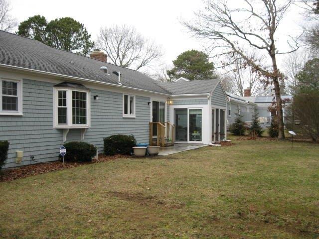 64 Ansel Howland Road Centerville, MA 02632 - Photo 30 of 31 a view of a house with a yard and a large tree