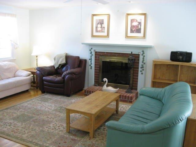 64 Ansel Howland Road Centerville, MA 02632 - Photo 7 of 31 a living room with furniture and a fireplace