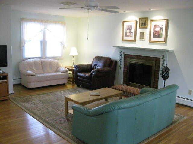 64 Ansel Howland Road Centerville, MA 02632 - Photo 8 of 31 a living room with furniture and a fireplace
