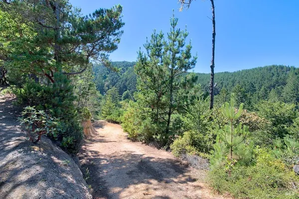 a backyard of a house with a yard and outdoor seating