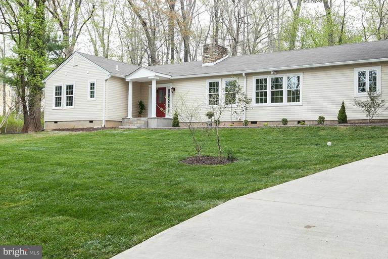 a front view of a house with a garden and yard