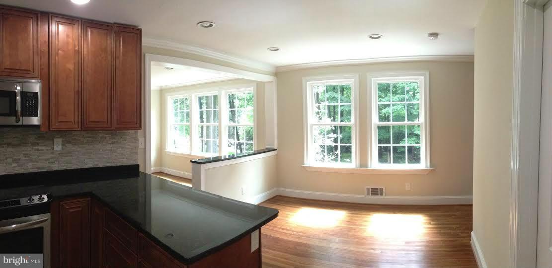 700 Midland Road Silver Spring, MD 20904 - Photo 2 of 17 a view of a kitchen with wooden floor and staircase
