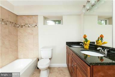 700 Midland Road Silver Spring, MD 20904 - Photo 10 of 17 a bathroom with a granite countertop sink a mirror and a toilet