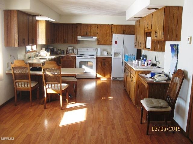 795 North Mammoser Road Stockton, IL 61085 - Photo 3 of 16 a kitchen with stainless steel appliances wooden floors and wooden cabinets