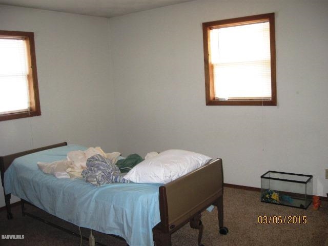 795 North Mammoser Road Stockton, IL 61085 - Photo 5 of 16 a bed sitting in a bedroom next to a window