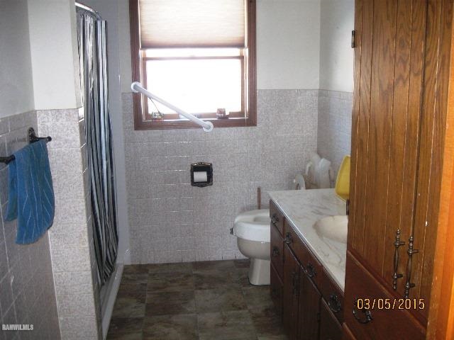 795 North Mammoser Road Stockton, IL 61085 - Photo 7 of 16 a bathroom with a granite countertop sink toilet and shower