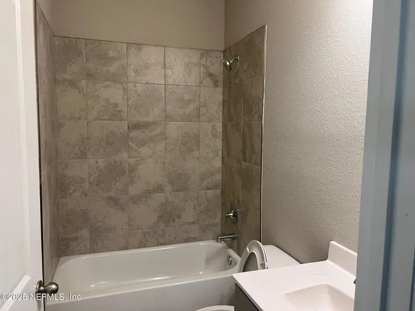 a bathroom with a bathtub and a toilet