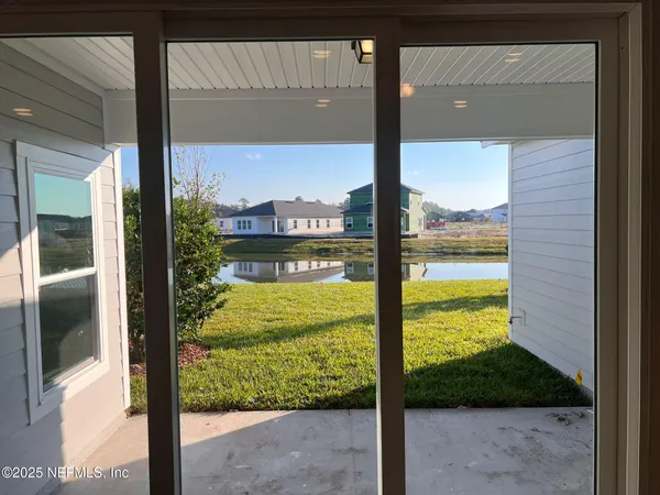 a view of a glass door and the balcony