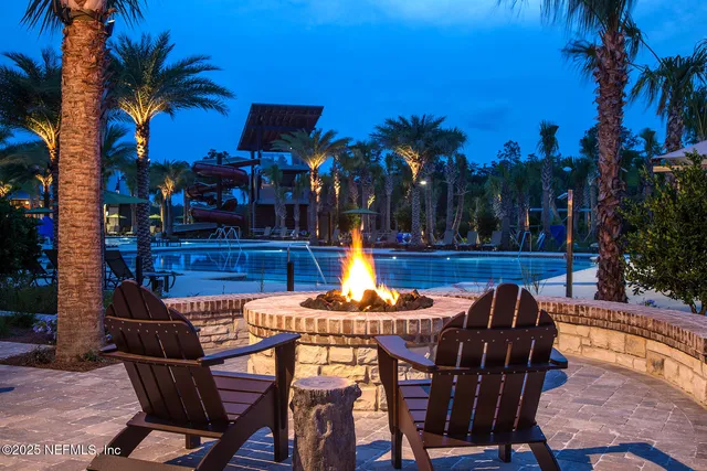 a view of a swimming pool with a patio and a porch