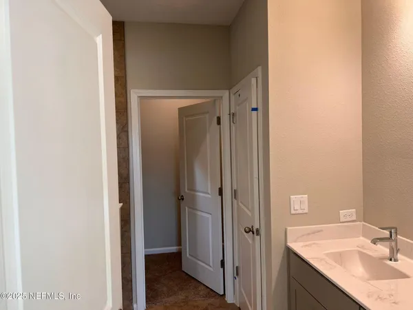 a bathroom with a granite countertop sink and shower