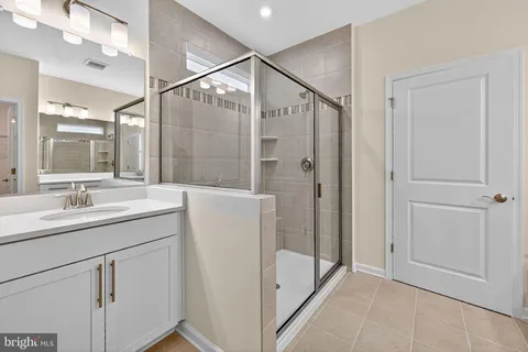 a bathroom with a double vanity sink and mirror