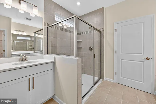 a bathroom with a double vanity sink and mirror