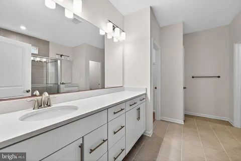 a bathroom with a double vanity sink and a mirror