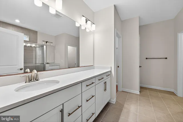 a bathroom with a double vanity sink and a mirror