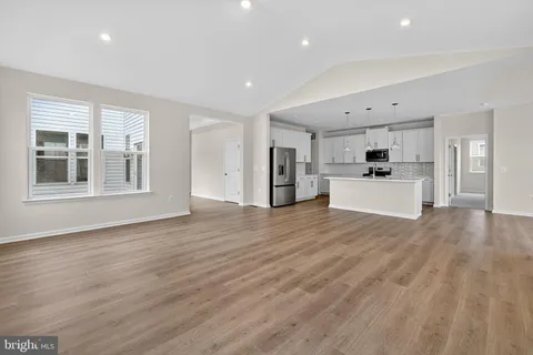 a view of a kitchen with a stove cabinets and wooden floor